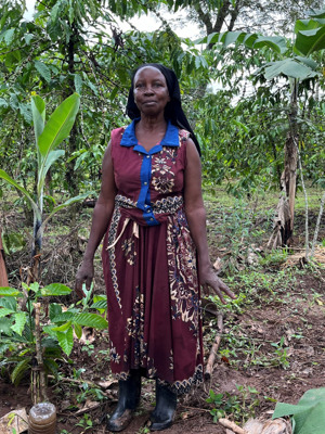 Woman in dress in the field pointing at plants